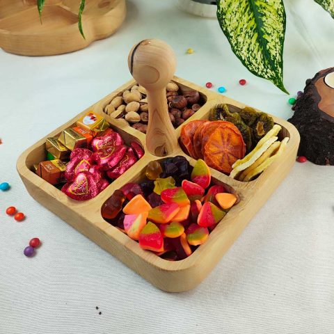 اردو خوری دسته دار چوبی چهارخانه پر از خوراکی های خوشمزه و میوه‌های خشک